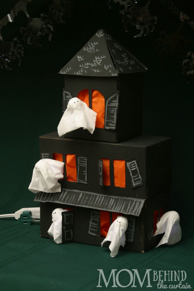 Here's a Halloween craft your kids can help with that makes a great centerpiece decoration for your Halloween party. A Haunted House out of recycled boxes!