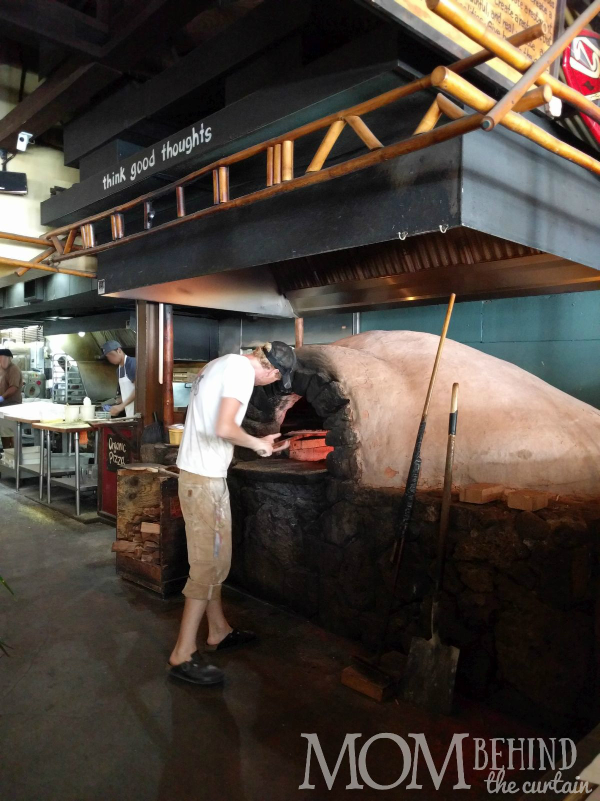 Man putting pizza in wood fired over, Best placae for lunch on Maui The Flatbread Company, Pa'ia