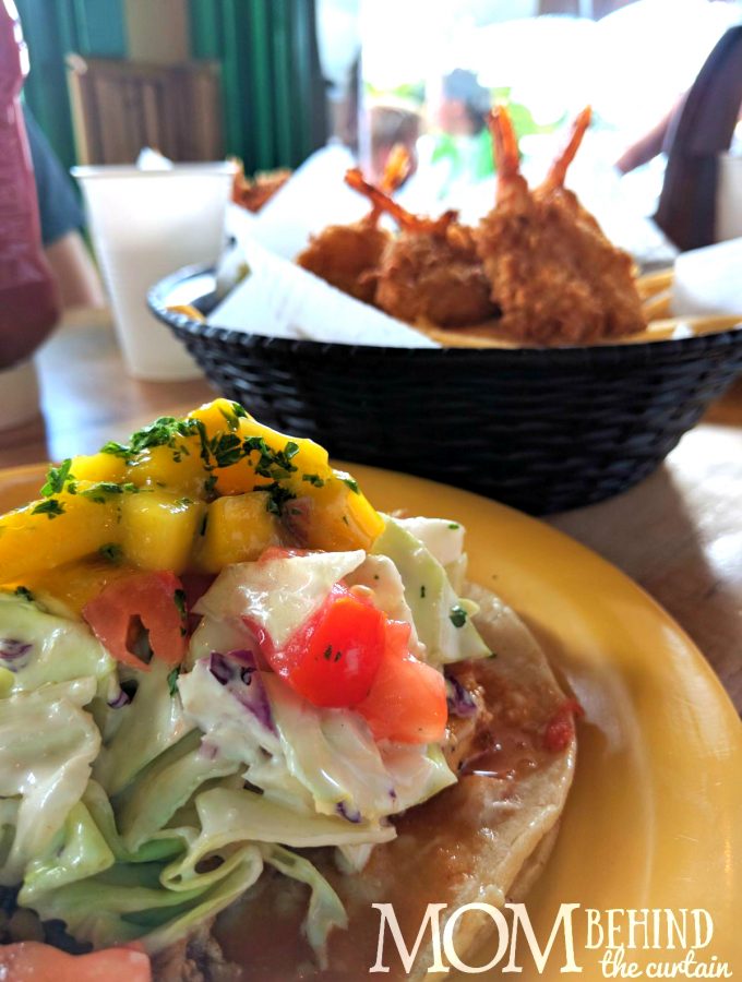 Best places to eat in Maui - don't miss out on delicious meals like these coconut shrimp and Hawaiian fish tacos with tropical mango and slaw.